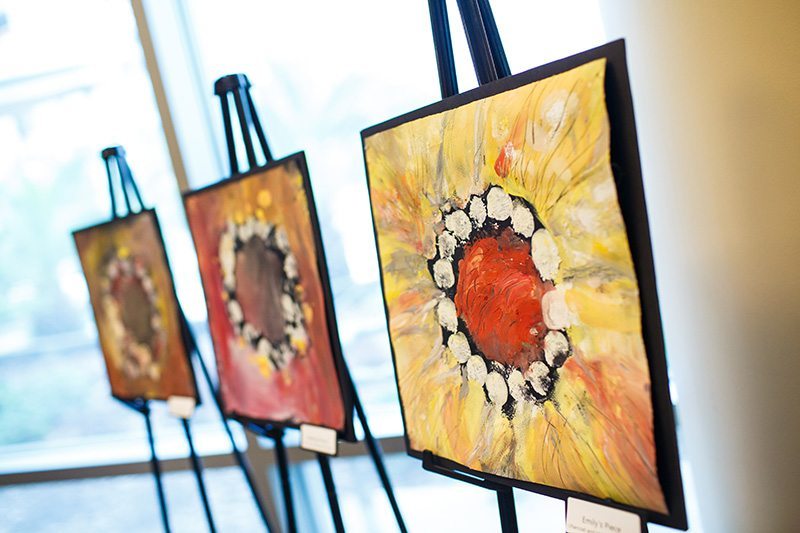 Artist living with ALS debuts new exhibit of works created using her feet