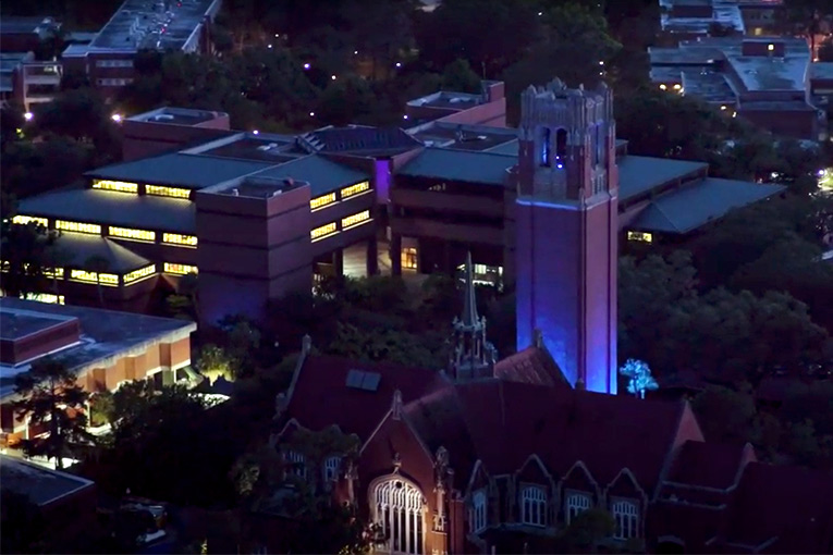 University of Florida’s Century Tower bathed in blue to honor health care workers